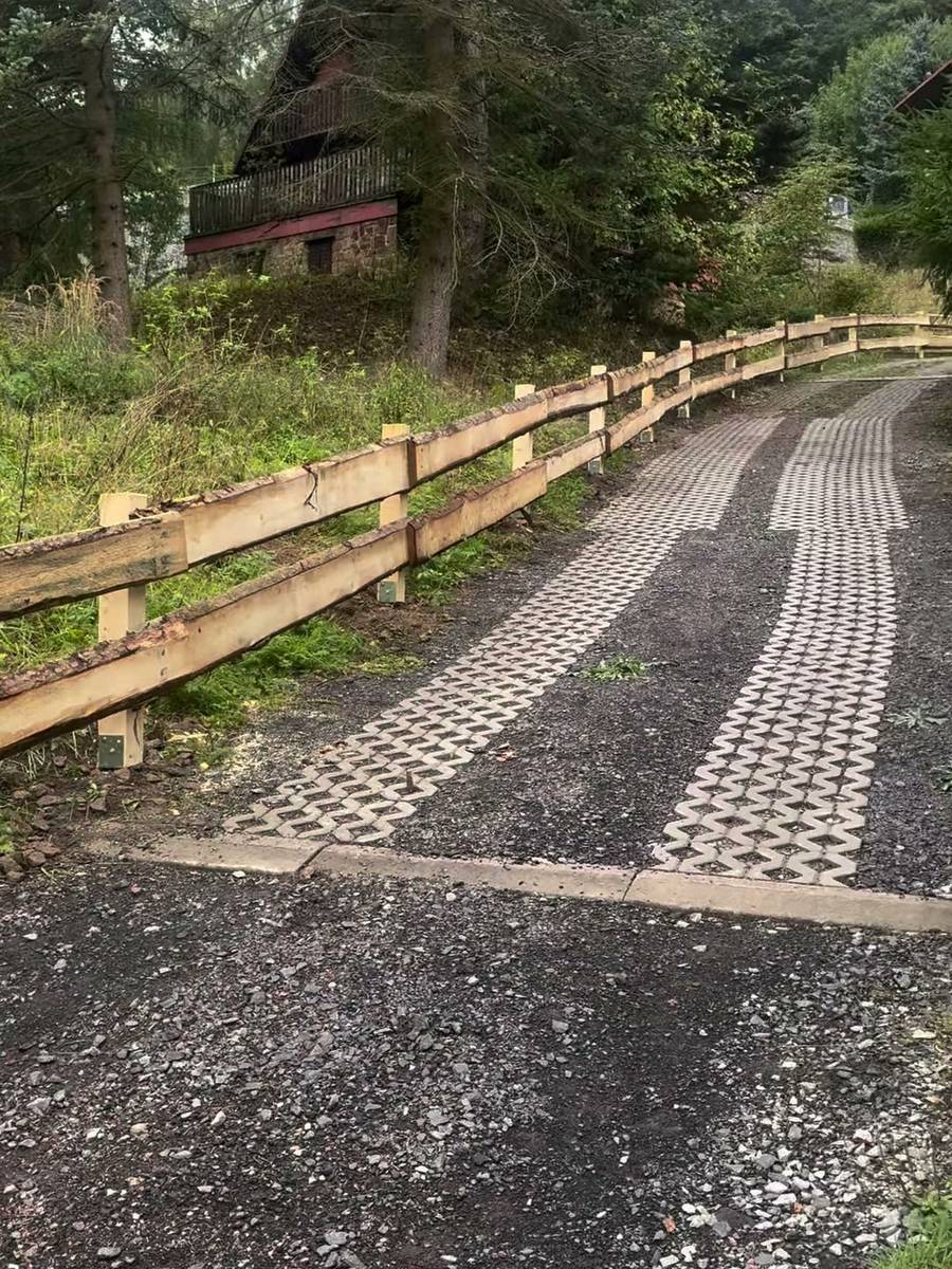 Příjezdová cesta se zatravňovacími dlaždicemi a dřevěným plotem